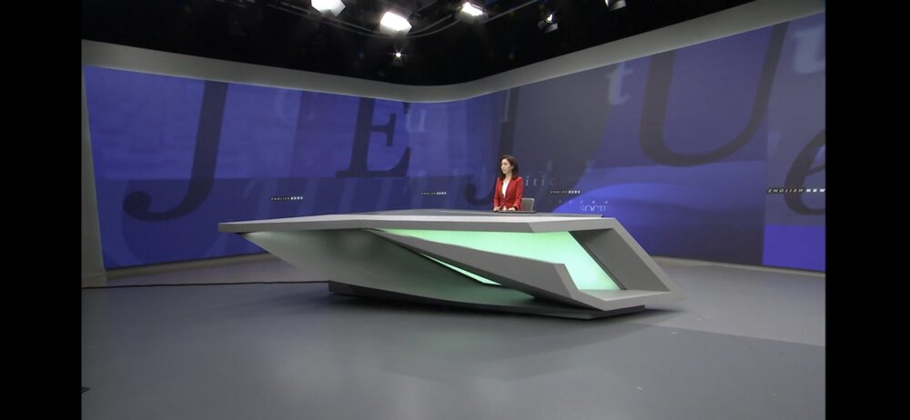 Jamie (Hee Jung) Lee anchoring the English news broadcast