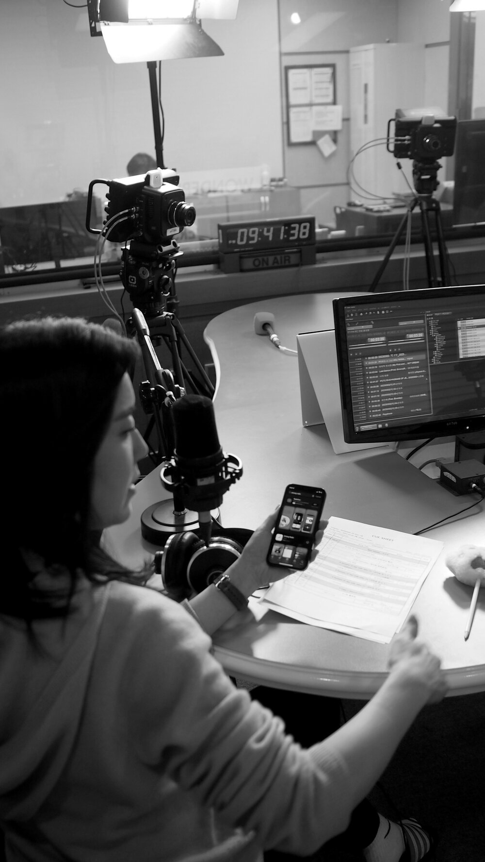 Jamie (Hee Jung) Lee behind the scenes in the radio booth before an on-air segment